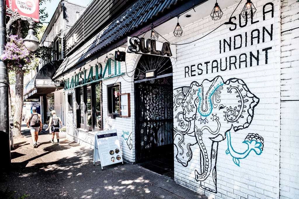 Best of Commercial Drive, Vancouver, BC, top 5 must-do activities, front of locally owned and operated Sula Indian Restaurant featuring a hand-painted mural of an elephant.