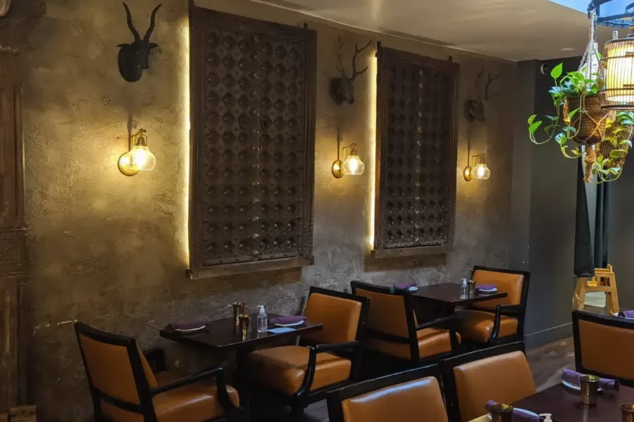 Sula Main Street dining room with hand-carved wall panels