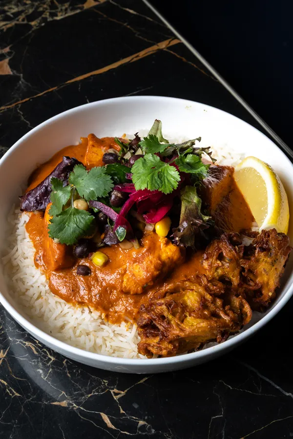 Butter chicken rice bowl with pakora at Sula happy hour, Vancouver