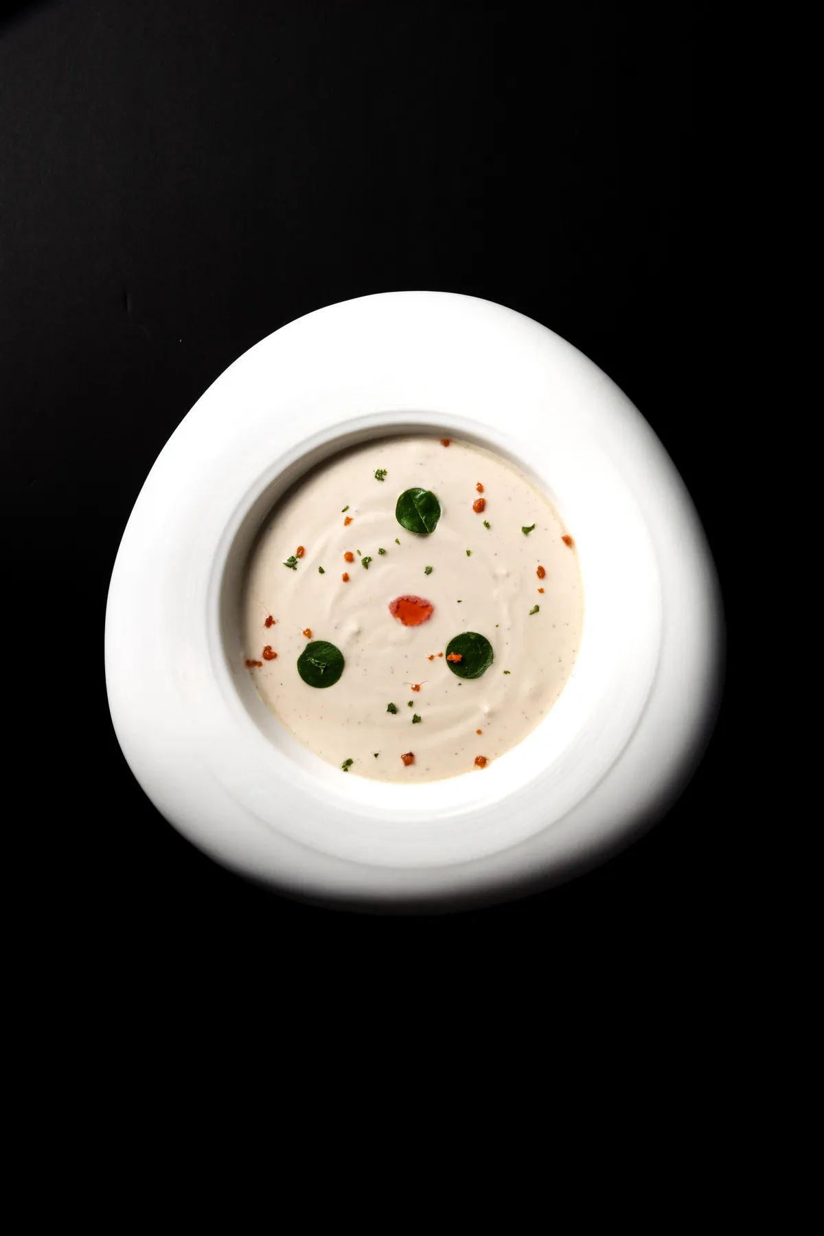 Coconut and kaffir lime Thukpa, the Sikkim course that opens the Spice Route tasting menu, a pale coconut broth finished with lime leaf and chilli oil.